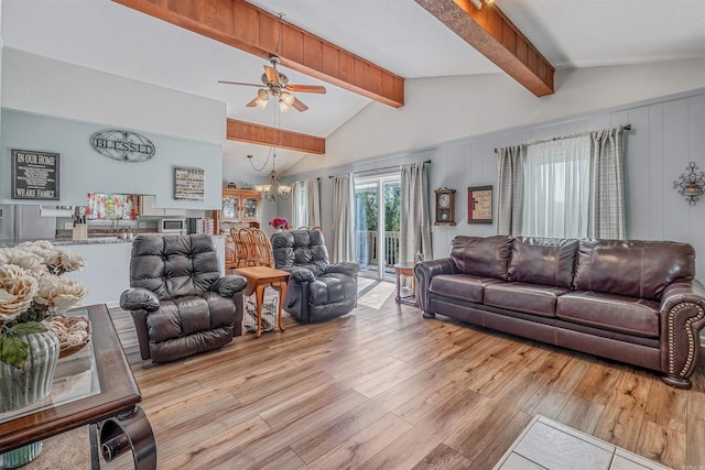 living room with lofted ceiling with beams, light wood-type flooring, and ceiling fan with notable chandelier