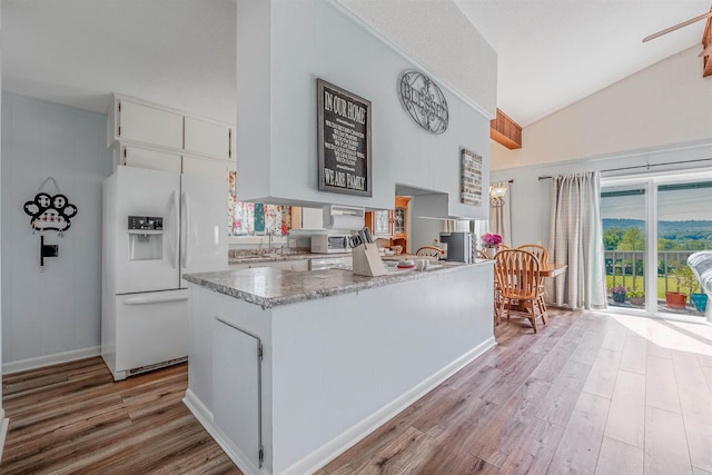 kitchen with light wood-type flooring, sink, white appliances, and white cabinetry