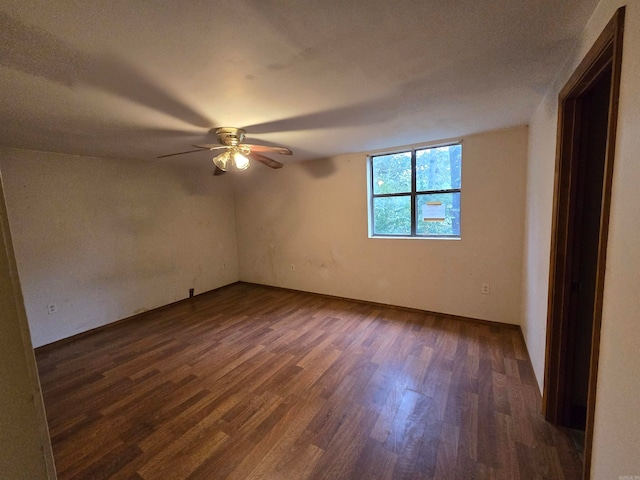 empty room with ceiling fan, a textured ceiling, and dark hardwood / wood-style floors