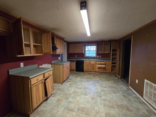 kitchen with a textured ceiling, black dishwasher, and sink