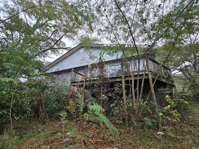 view of home's exterior with a wooden deck