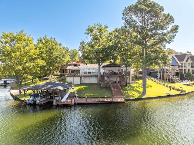 rear view of property with a yard and a deck with water view