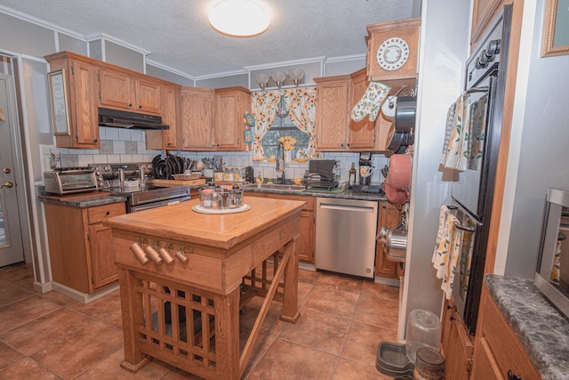 kitchen with appliances with stainless steel finishes, decorative backsplash, a textured ceiling, ornamental molding, and sink