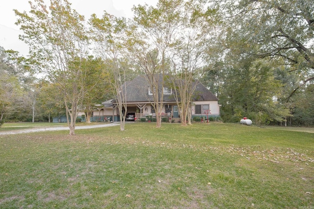 cape cod home with a front lawn