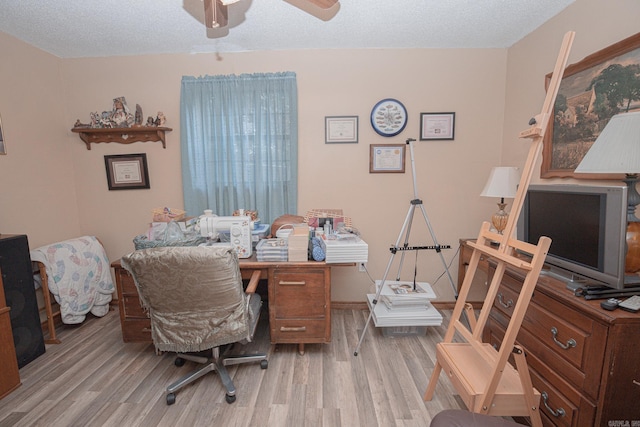 office space featuring a textured ceiling, light hardwood / wood-style floors, and ceiling fan