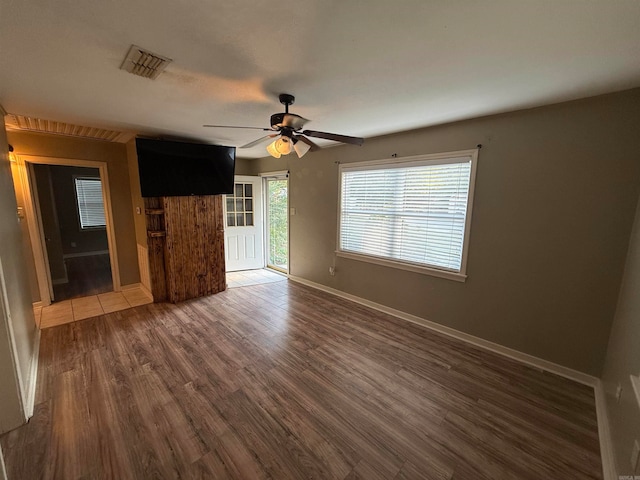 spare room featuring dark hardwood / wood-style flooring and ceiling fan