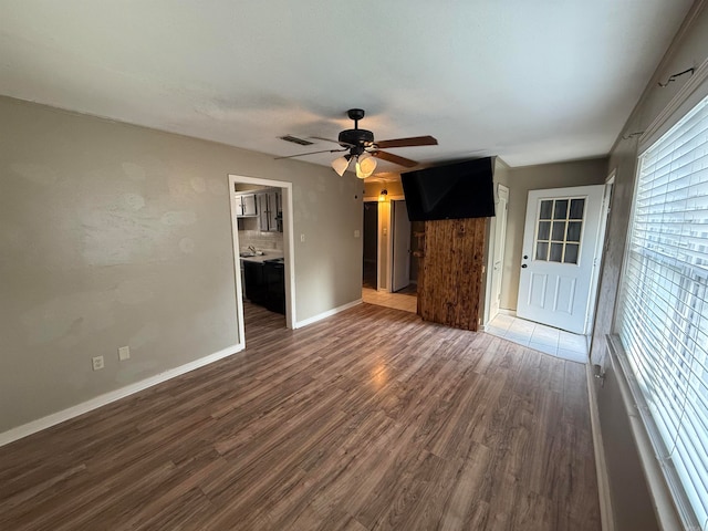 unfurnished living room with ceiling fan and dark hardwood / wood-style flooring