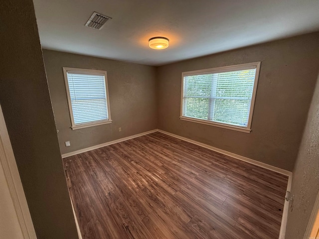 spare room featuring dark hardwood / wood-style flooring