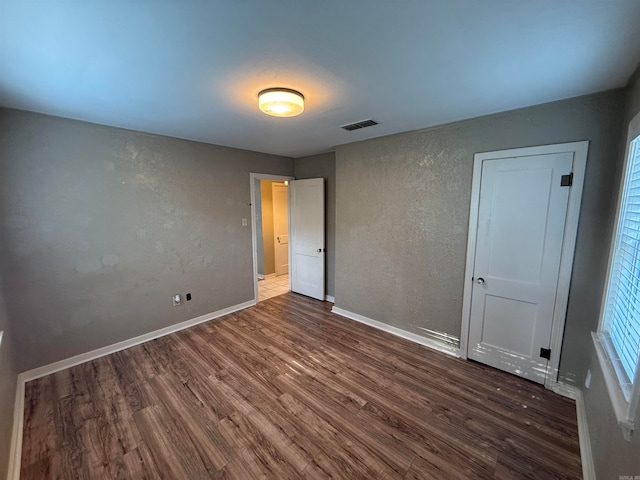 unfurnished bedroom with hardwood / wood-style floors