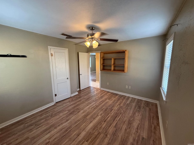 unfurnished bedroom featuring ceiling fan and hardwood / wood-style floors