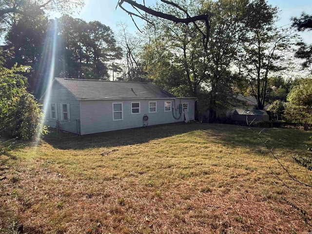 rear view of house with a yard