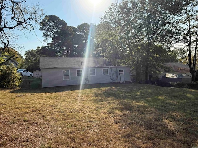 rear view of property featuring a yard