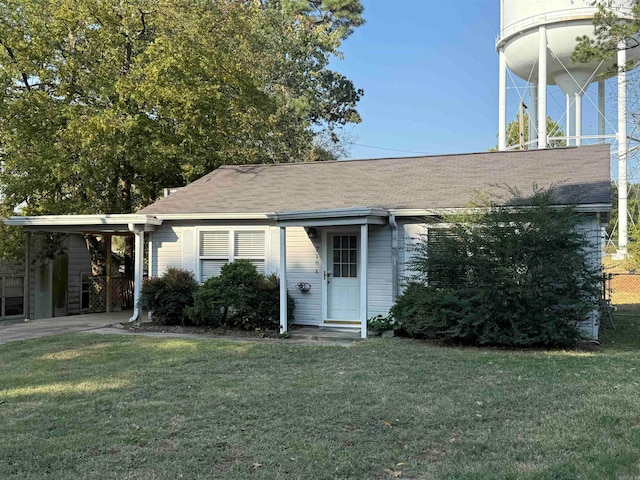 view of front facade with a front yard and a carport