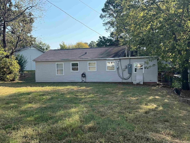 rear view of house with a yard