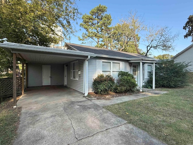 ranch-style home with a front lawn and a carport