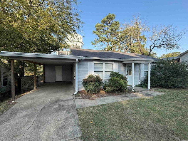 view of front of property with a front lawn and a carport