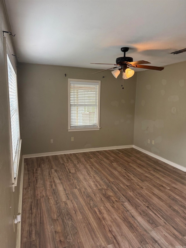 spare room featuring dark hardwood / wood-style floors and ceiling fan