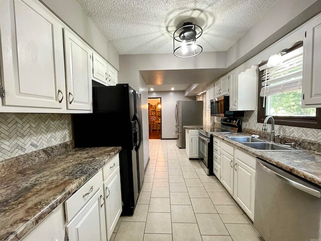 kitchen featuring white cabinets, appliances with stainless steel finishes, and sink