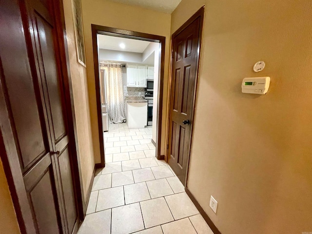 corridor with light tile patterned floors