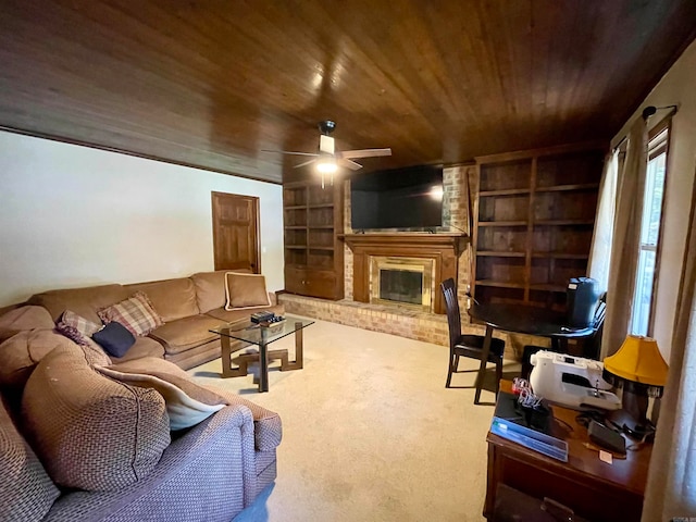 living room featuring carpet flooring, built in shelves, a brick fireplace, ceiling fan, and wooden ceiling