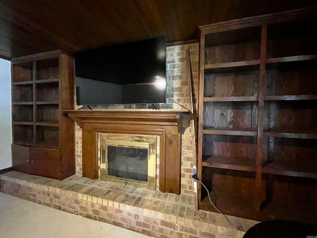 unfurnished living room with wood ceiling, a fireplace, and carpet