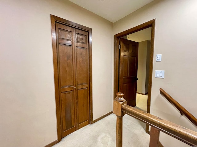 hallway featuring light carpet