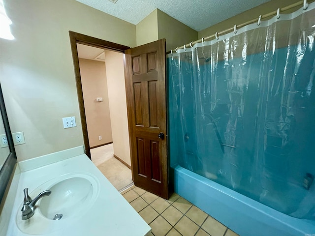 bathroom with shower / bathtub combination with curtain, a textured ceiling, tile patterned floors, and sink