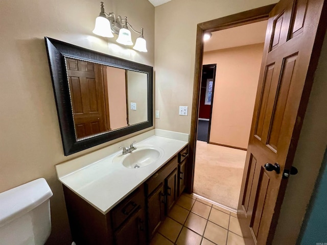 bathroom featuring tile patterned flooring, vanity, and toilet