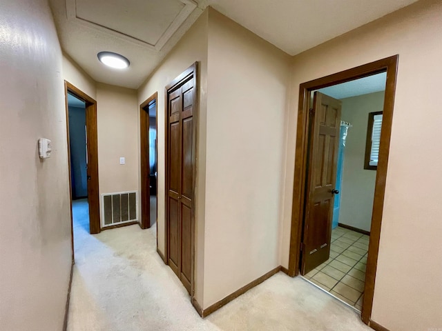 hallway with light colored carpet