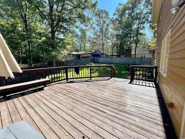 wooden deck with a lawn