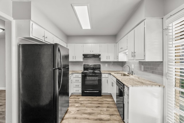 kitchen with white cabinets, black appliances, light wood-type flooring, and sink