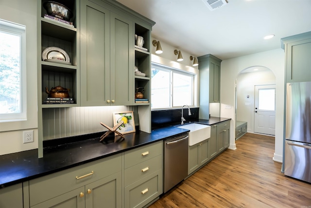 kitchen with light hardwood / wood-style flooring, appliances with stainless steel finishes, sink, and a healthy amount of sunlight