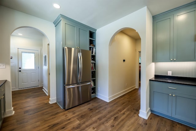 kitchen with stainless steel fridge and dark hardwood / wood-style floors