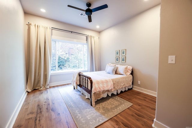 bedroom with wood-type flooring and ceiling fan