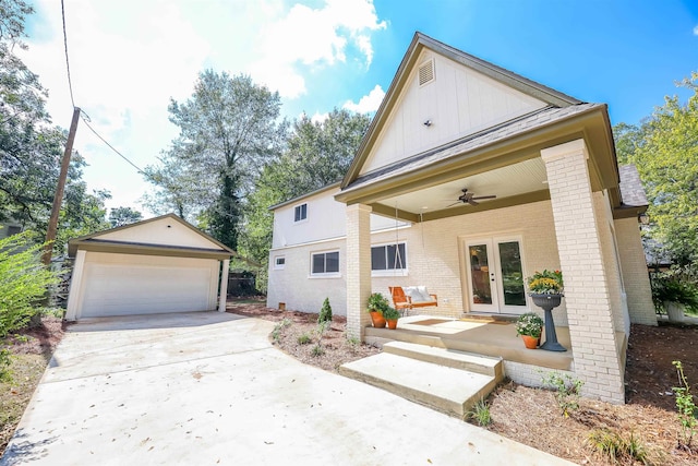 view of front of house with ceiling fan, an outdoor structure, french doors, and a garage