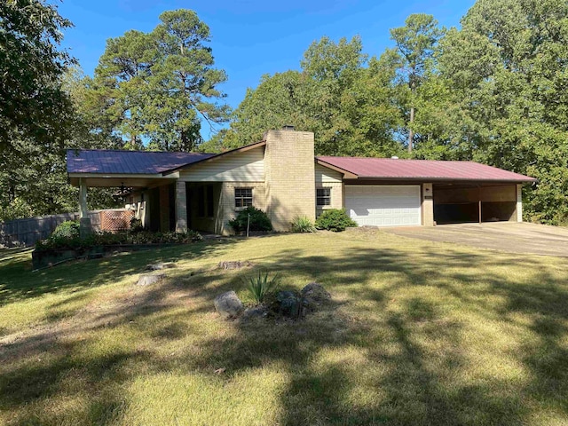 ranch-style home featuring a garage and a front lawn