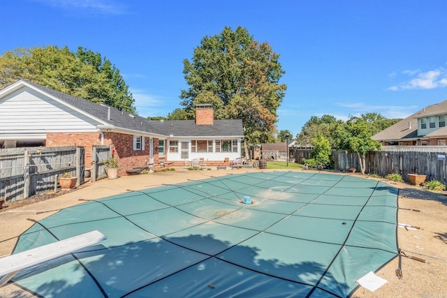 view of pool featuring a patio and a diving board