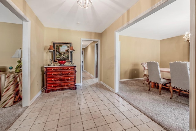 interior space with light carpet and a chandelier