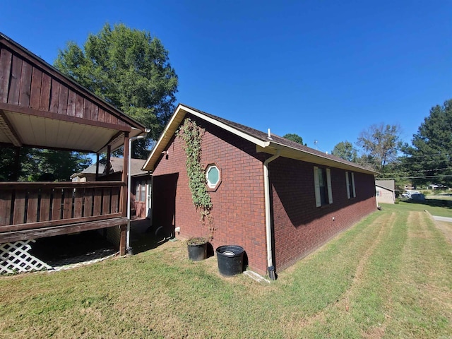 view of property exterior with a deck and a yard