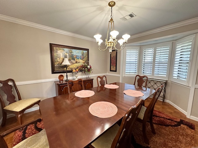 dining room with dark hardwood / wood-style flooring, a chandelier, and crown molding