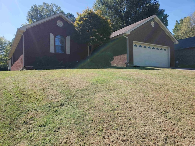 single story home featuring a garage and a front lawn