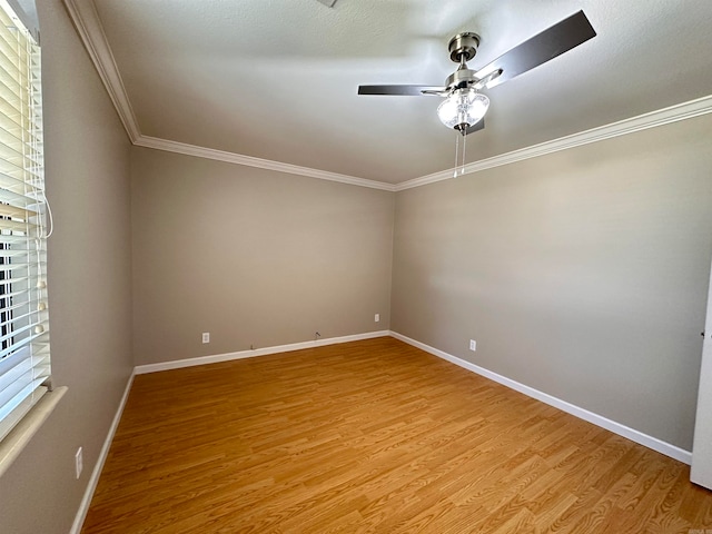 empty room featuring ceiling fan, ornamental molding, and light hardwood / wood-style floors