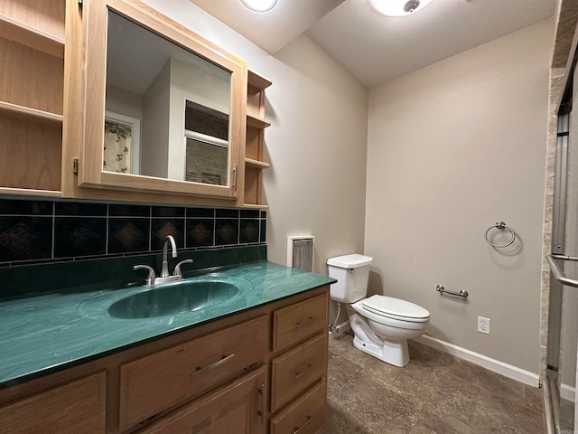 bathroom featuring decorative backsplash, vanity, toilet, and a shower with door