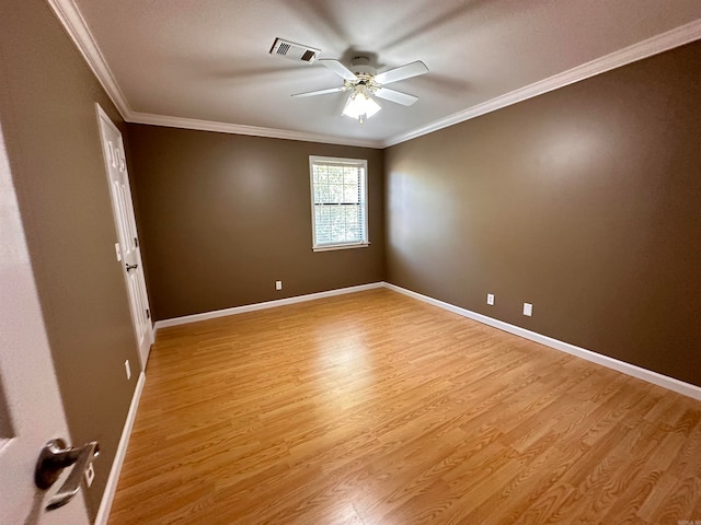 empty room featuring light hardwood / wood-style flooring, ceiling fan, and ornamental molding