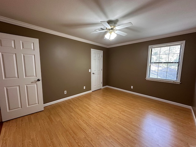 spare room with ornamental molding, ceiling fan, and light hardwood / wood-style flooring