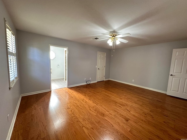 spare room with wood-type flooring and ceiling fan