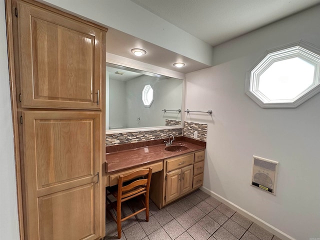 bathroom with decorative backsplash, tile patterned flooring, and vanity