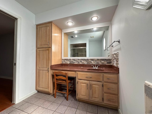 bathroom with backsplash, tile patterned flooring, vanity, and a shower with shower door