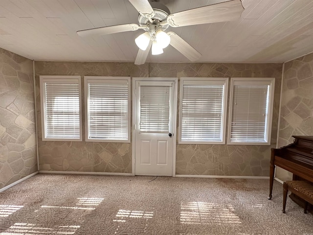 sunroom / solarium featuring ceiling fan and wooden ceiling