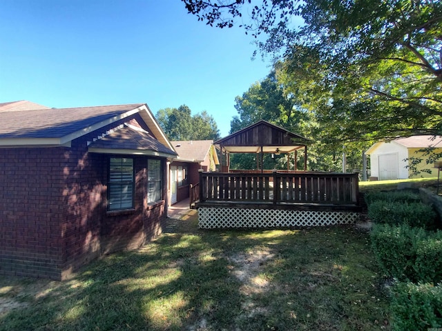 view of yard with a deck and a storage unit